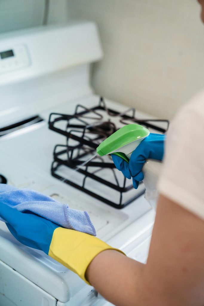 Person Spraying All Purpose Cleaner to a Cloth